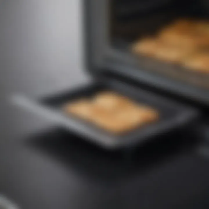 Close-up view of the Breville Smart Oven Air's crumb tray highlighting its design and material.