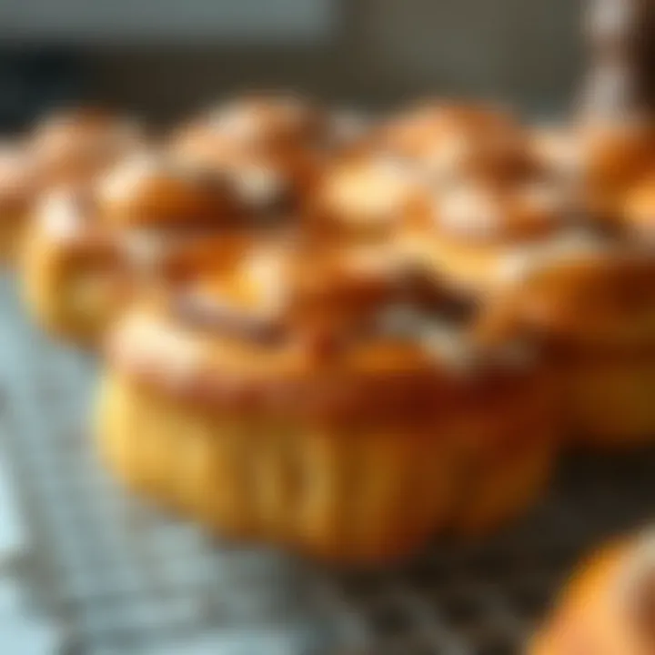 Golden brown cinnamon rolls resting on a cooling rack