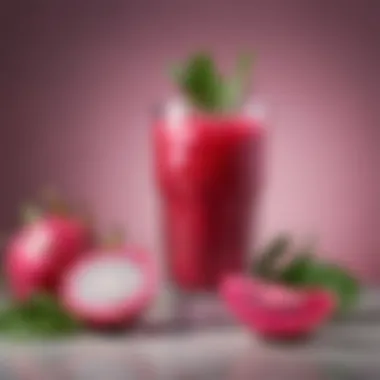 Refreshing Dragon Fruit Beverage Glass filled with a refreshing pink beverage garnished with slices of lime and mint leaves