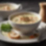 A bowl of creamy chicken soup with herbs and spices