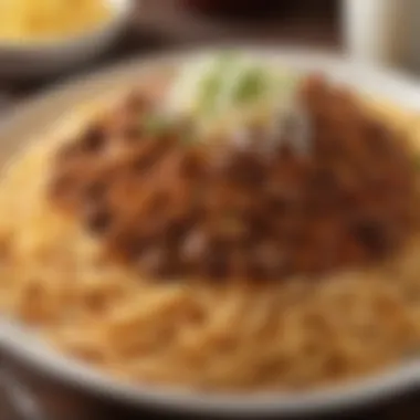 A vibrant dish showcasing Cincinnati's famous chili served over spaghetti, garnished with cheese and onions.