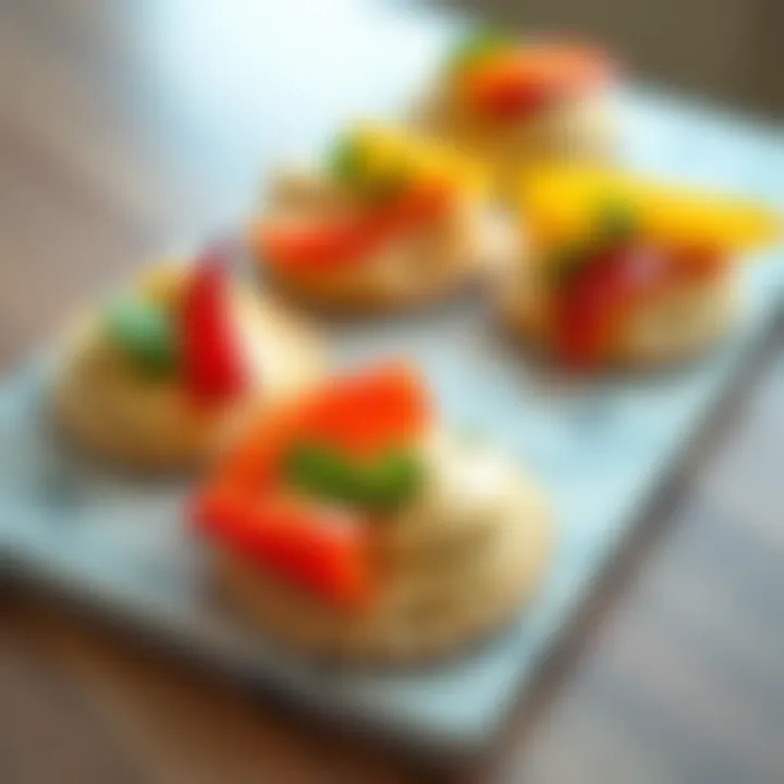 Hummus and Bell Pepper Medley An artistic arrangement of hummus spread on crisp crackers, adorned with colorful bell peppers and herbs.