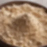 A close-up view of malted milk powder in a decorative bowl, showcasing its texture and color.