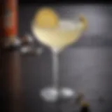 An elegant glass of the Corpse Reviver cocktail garnished with a twist of lemon.