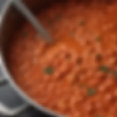 A close-up of simmering tomato sauce in a pot, capturing the essence of a home-cooked meal with aromatic spices.