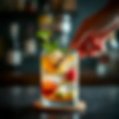 Cocktail ingredients being muddled in a glass with a muddler