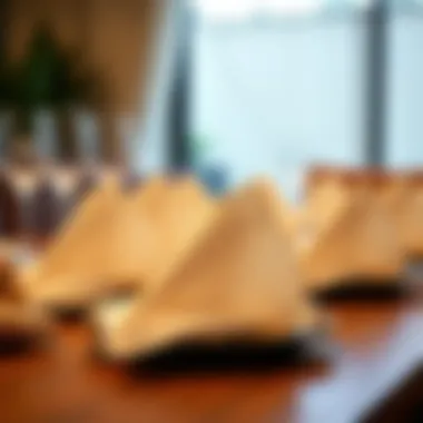 Elegant Display of Pre-Folded Napkins Elegant display of pre-folded paper napkins on a dining table.