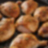Freshly seasoned chicken breasts ready for skillet cooking