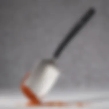 Sleek Design of Metal Spatula with Silicone Edge Close-up view of a metal spatula with a silicone edge showcasing its sleek design.
