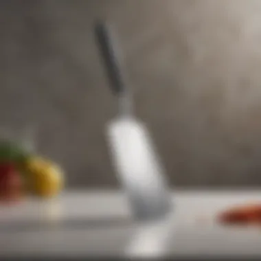 Metal Spatula on a Modern Kitchen Counter Metal spatula with silicone edge resting on a modern countertop.